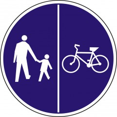 Pedestrians on the left side of the road and bicycles on the right