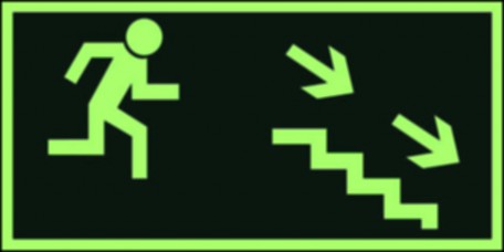 Znak ewakuacyjny - Kierunek do wyjścia drogi ewakuacyjnej schodami w dół w prawo